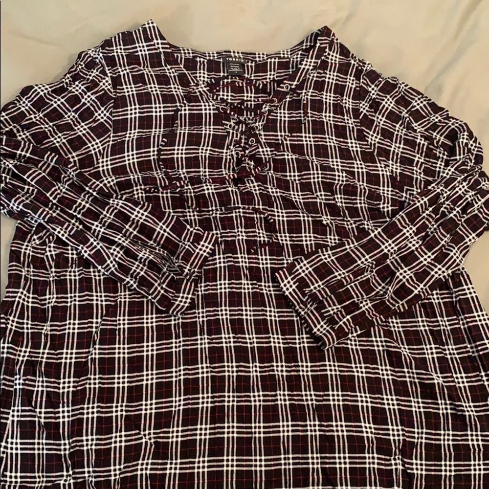 Flannel patterned blouse with lace up neck line.